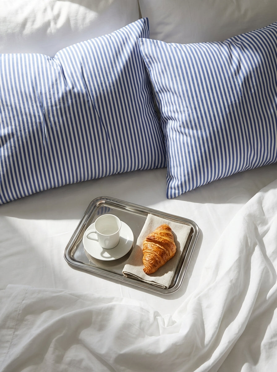 St Tropez Stripe pillowcases on a white bedding and a breakfast tray