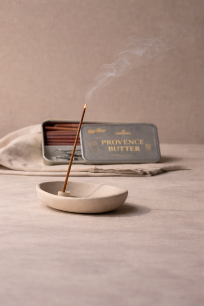 Incense stick in Provence Butter burning on a neutral background