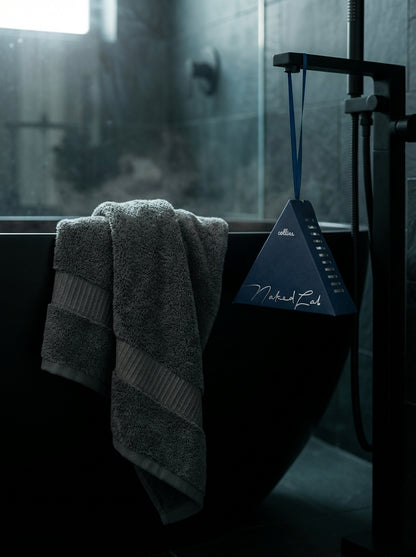 Nighttime fragrance sachet in Palau Midnight Navy hanging in dark bathroom